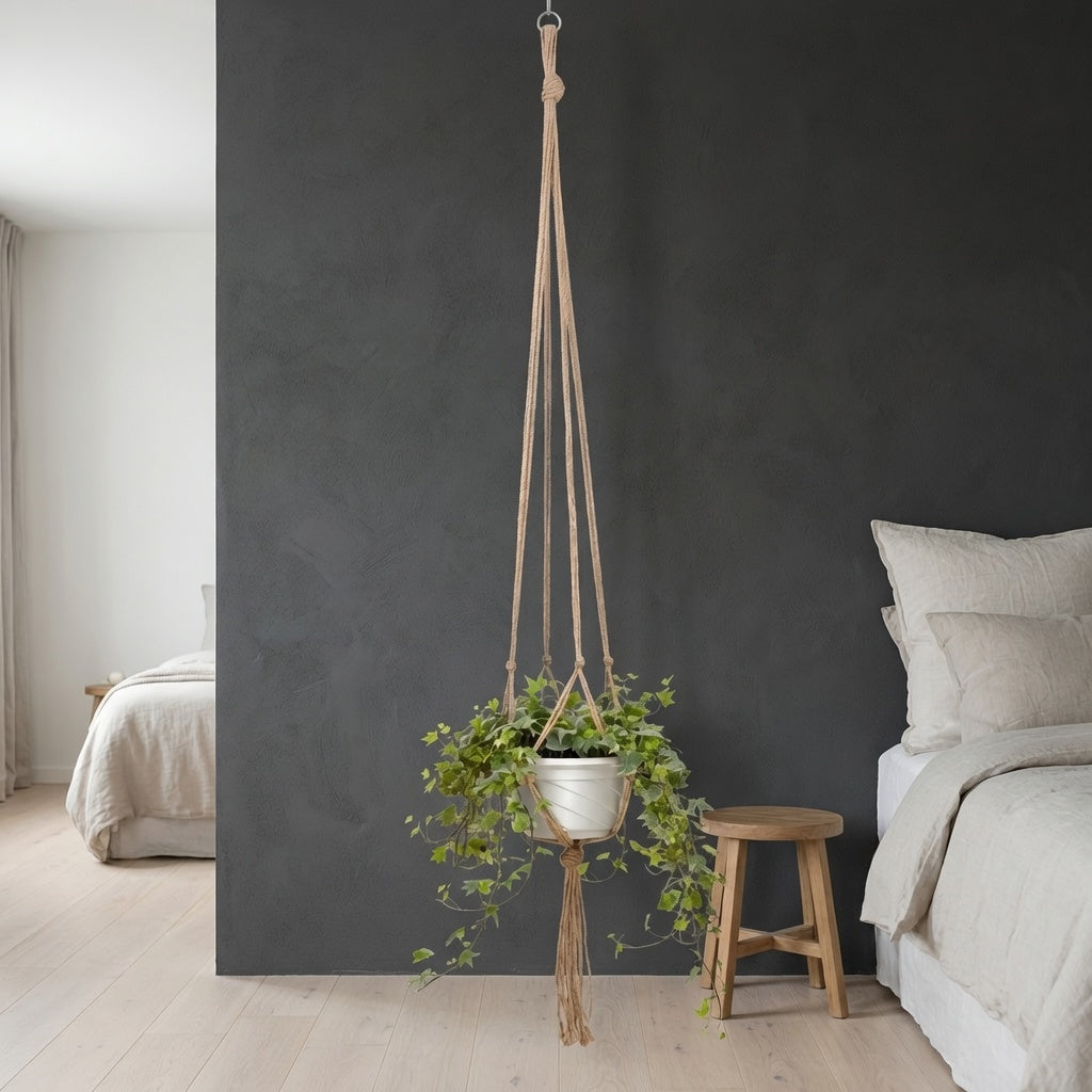 Jute plant hanger with white pot and green plant in a scandi bedroom