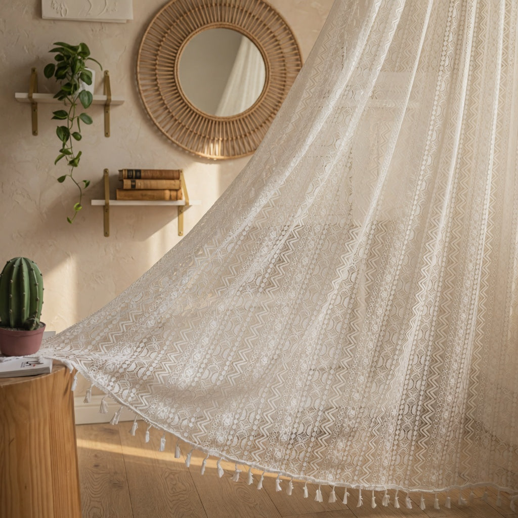 Beige woven blanket draped over a wooden surface with a wicker mirror and plant in the background.