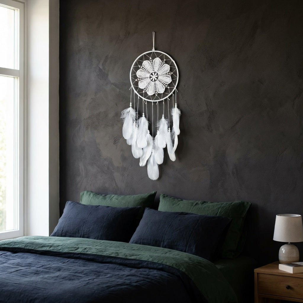 White feather dream catcher on dark charcoal wall above bed — boho bedroom wall decor