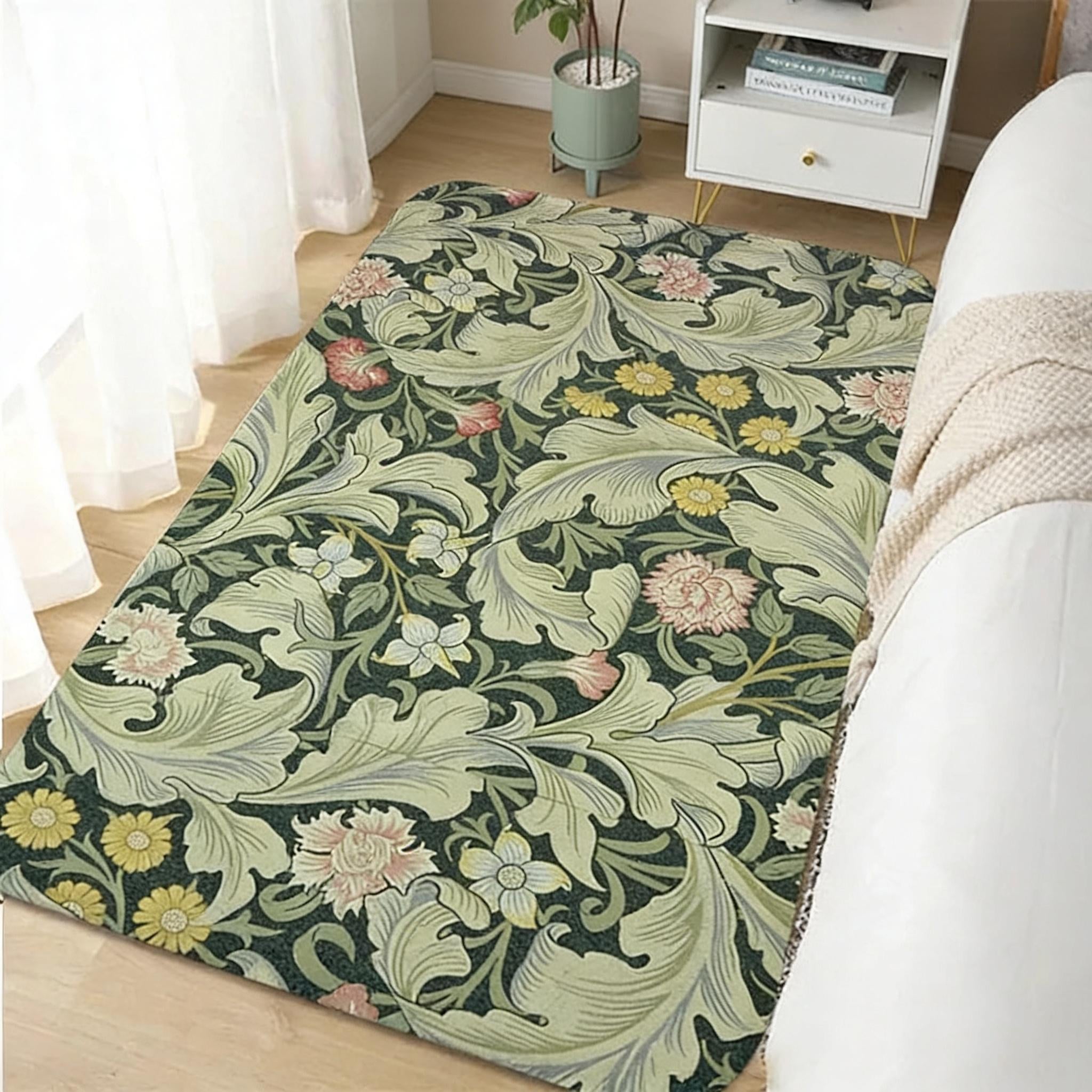 Light sage green William Morris floral area rug in a living room with a white sofa and potted plant