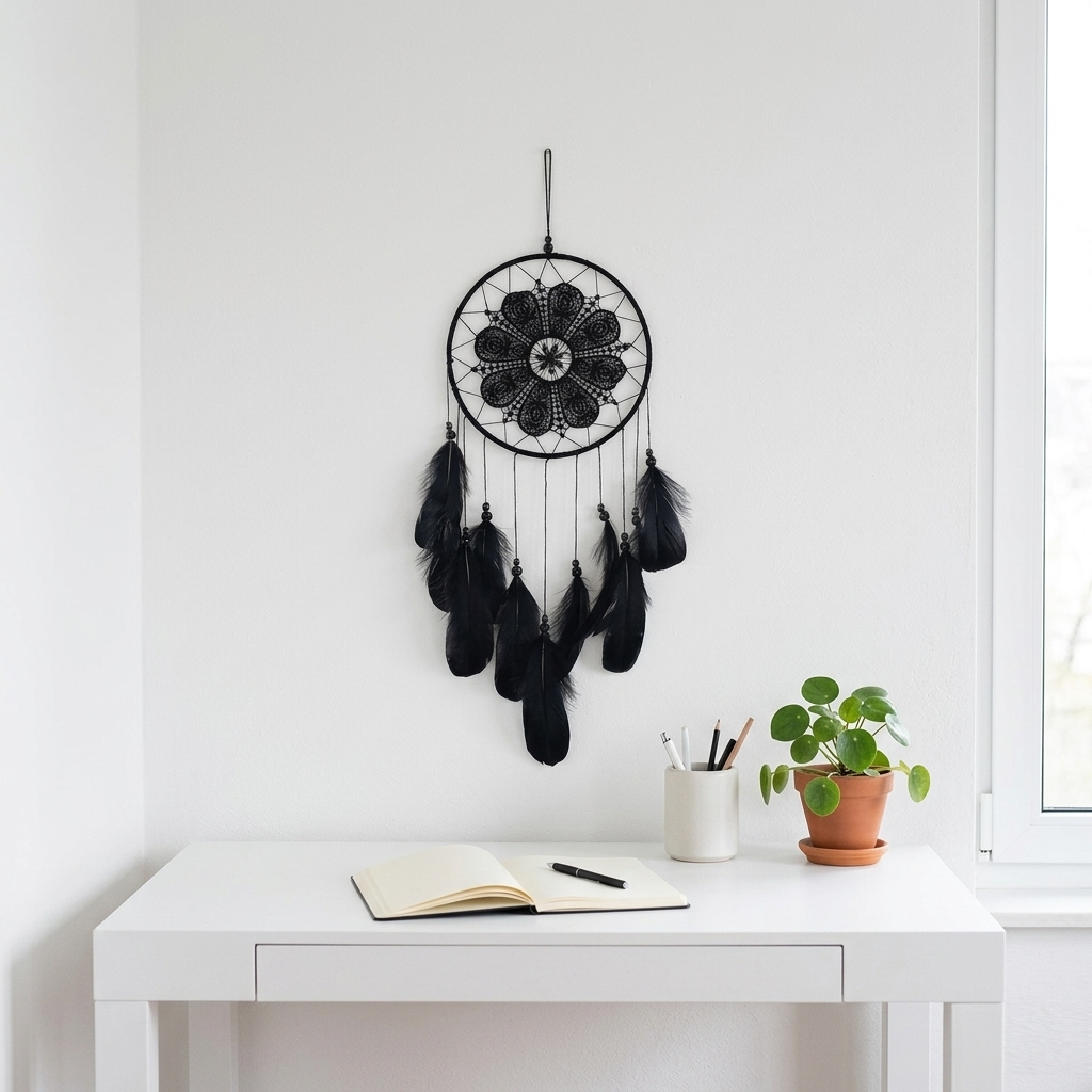 Black lace dream catcher with dark feathers on white wall — minimalist home office decor