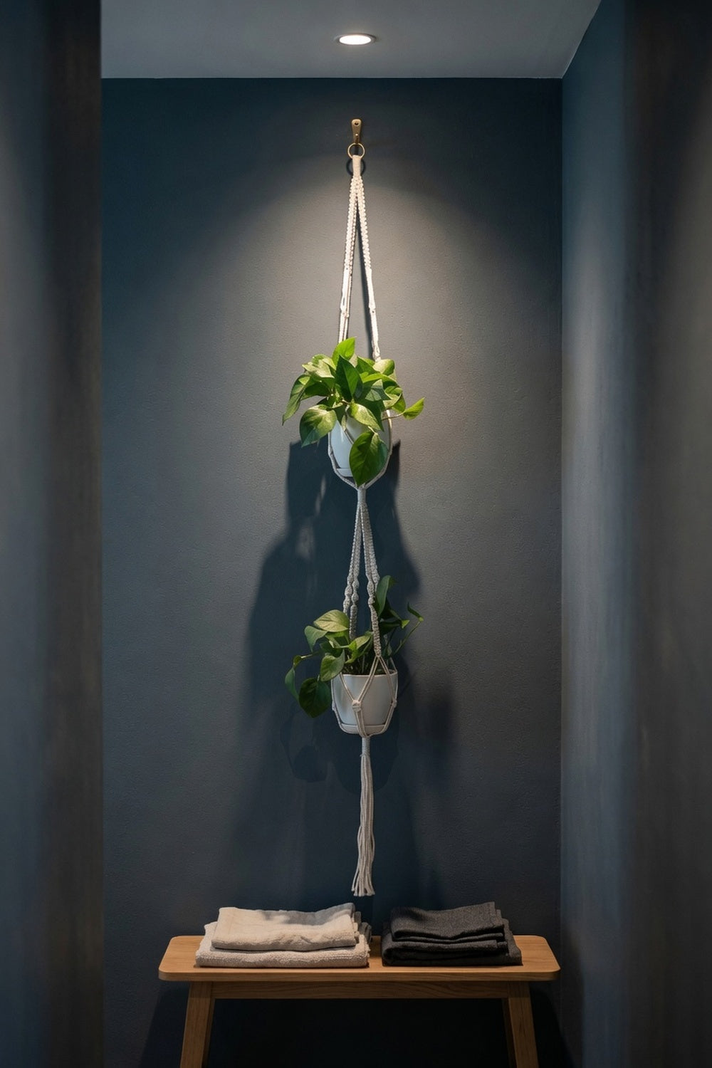 Long macrame plant hanger with knot bead texture near terracotta archway entrance