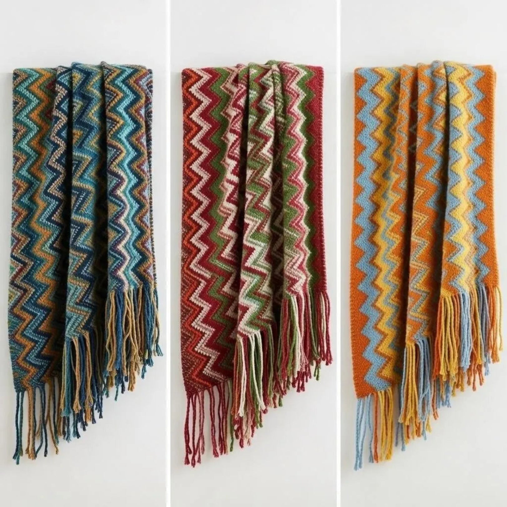 Three folded chevron fringe throw blankets in blue, red, and orange