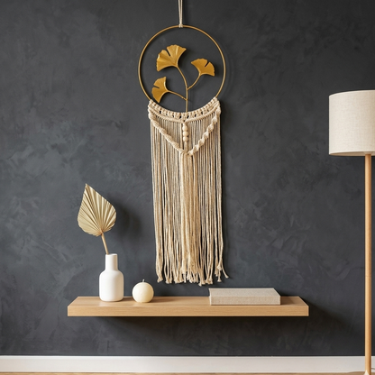 Gold hoop ginkgo leaf macrame wall hanging on charcoal grey wall above oak floating shelf Scandinavian decor — Bohoartis