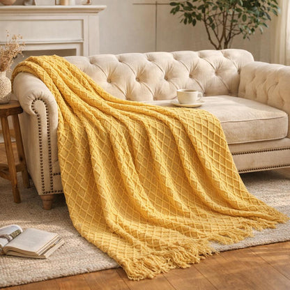 Knit tassel throw blanket draped over sofa