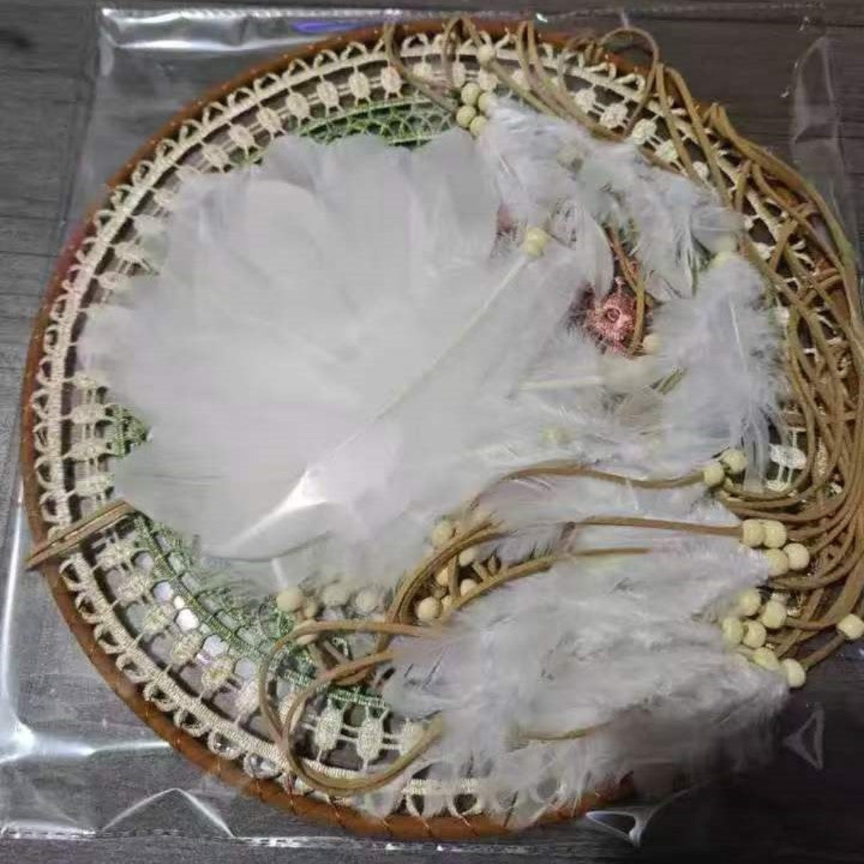 Dreamcatcher with feathers and beads on a clear background