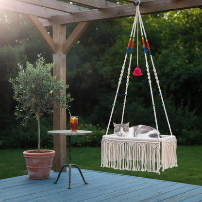 Macrame hanging cat bed on a boho patio with a potted plant nearby — Bohoartis
