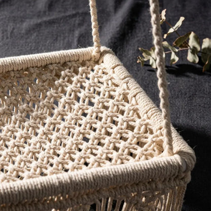 Close-up of hand-knotted cotton rope, wooden beads, and fringe on this woven cat bed