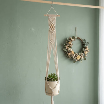 Boho macrame plant hanger with wooden dowel in cottagecore nursery sage green wall dried flower wreath