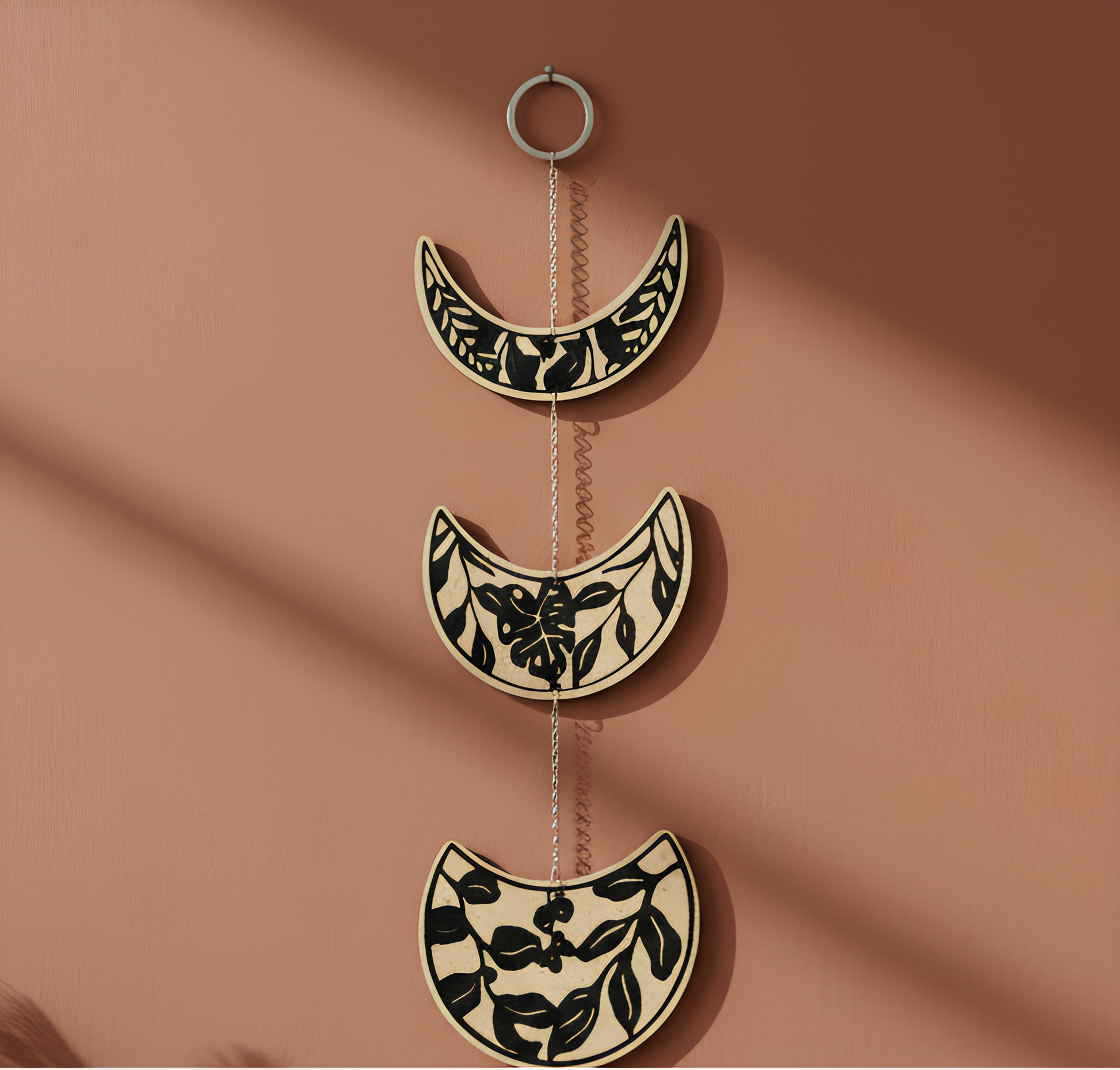 Moon phase lunar cycle garland with metal chain links and black botanical pattern on ivory discs