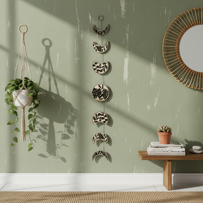 Moon phase garland displayed in boho living room with macrame wall hanging and rattan shelf