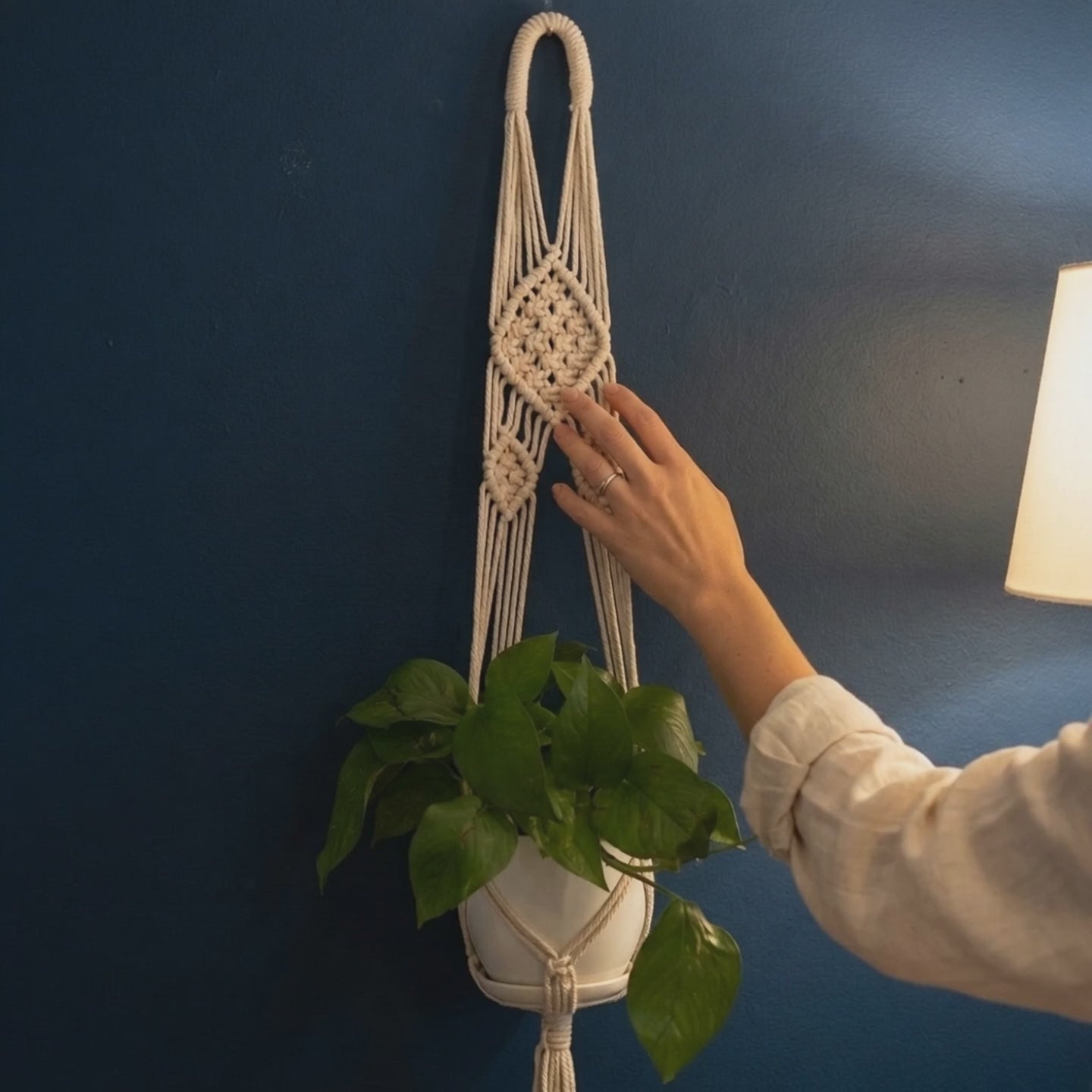 Hand touching lace flower medallion weave on macrame plant hanger