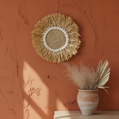 Woven wall art with a vase of dried plants on a terracotta wall