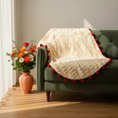 Rose bouquet throw blanket draped over green sofa with autumn floral arrangement — cozy sofa blanket rose home decor living room