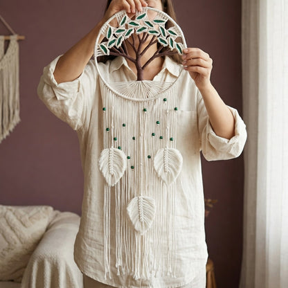Woman holding large boho macrame wall hanging with white leaf tassels, tree of life cotton rope gift idea